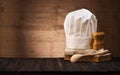 Chef`s hat, vintage cookbooks and wooden spoon on the kitchen table with space for text